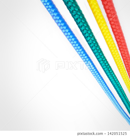 Textile, rope and string with color on background, mock up or space with nylon cable for creativity. Creative, ties and cord material to thread in pattern or start connection in craft or art project Textile, rope and string with color on background, mock up or space with nylon cable for creativity. Creative, ties and cord material to thread in pattern or start connection in craft or art project 142051525