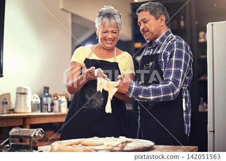 Cooking, love and senior couple in kitchen at home with dough, flour and ingredients for meal. Happy, food and elderly man and woman preparing dinner, lunch or supper together at house in Mexico. Cooking, love and senior couple in kitchen at home with dough, flour and ingredients for meal. Happy, food and elderly man and woman preparing dinner, lunch or supper together at house in Mexico. 142051563