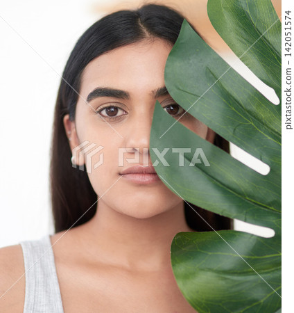 Plant, portrait and girl in studio for skincare with herbal cosmetics for daily skin routine in morning. Woman, isolated on white background with palm leaf for organic or natural dermatology and care Plant, portrait and girl in studio for skincare with herbal cosmetics for daily skin routine in morning. Woman, isolated on white background with palm leaf for organic or natural dermatology and care 142051574