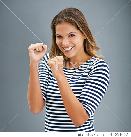 Happy, woman and fashion with fist or punch in portrait for casual self defense isolated in studio. Excited, female model and hands raised to fight with boxing pose for motivation and empowerment Happy, woman and fashion with fist or punch in portrait for casual self defense isolated in studio. Excited, female model and hands raised to fight with boxing pose for motivation and empowerment 142051602