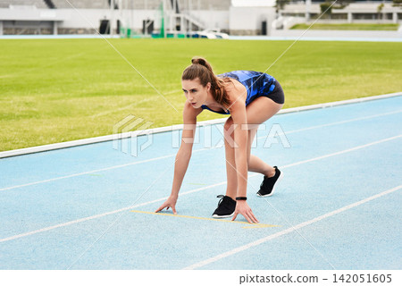 Start position, race track and woman for running, exercise and workout for sport outdoor by grass or ready on arena. Stadium, runner and athlete for wellness and gym for cardio, training or health Start position, race track and woman for running, exercise and workout for sport outdoor by grass or ready on arena. Stadium, runner and athlete for wellness and gym for cardio, training or health 142051605