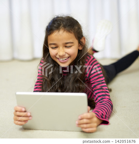 Happy, girl and tablet on floor in apartment for streaming, gaming and watch movie online. Smile, child and technology for education, elearning and connectivity on social media for school holiday Happy, girl and tablet on floor in apartment for streaming, gaming and watch movie online. Smile, child and technology for education, elearning and connectivity on social media for school holiday 142051676
