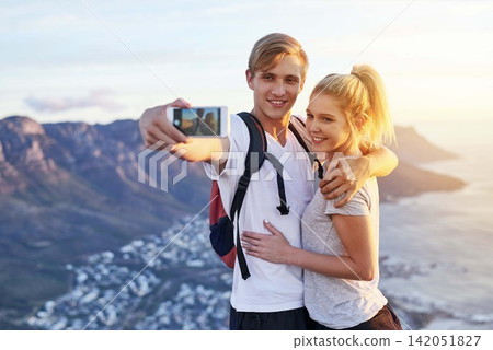 Couple, hiking and selfie on mountain with smile for adventure blog, update or online post together. Man, woman and happy with digital photography in nature for fitness, travel memory or social media Couple, hiking and selfie on mountain with smile for adventure blog, update or online post together. Man, woman and happy with digital photography in nature for fitness, travel memory or social media 142051827