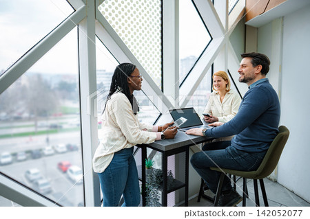 Professional diverse business team meeting together Professional diverse business team meeting together 142052077