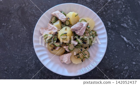Steamed potatoes and chicken with okra and eggplant Steamed potatoes and chicken with okra and eggplant 142052437