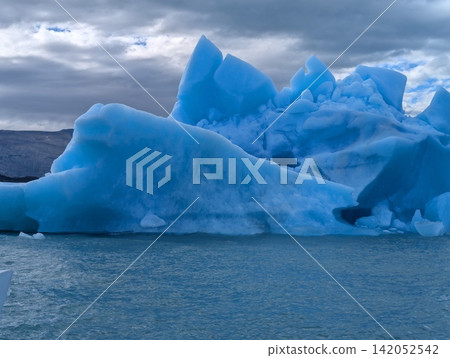 Close View of Jagged Blue Iceberg with Deep Ice Cavities Close View of Jagged Blue Iceberg with Deep Ice Cavities 142052542