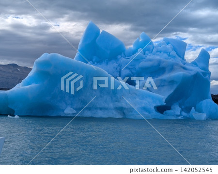 Massive Blue Iceberg with Angular Peaks and Low Ice Ridge Massive Blue Iceberg with Angular Peaks and Low Ice Ridge 142052545