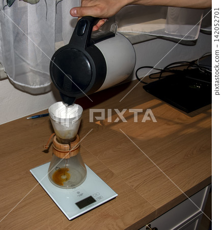 Pouring Hot Water into Pour-Over Coffee Filter Pouring Hot Water into Pour-Over Coffee Filter 142052701