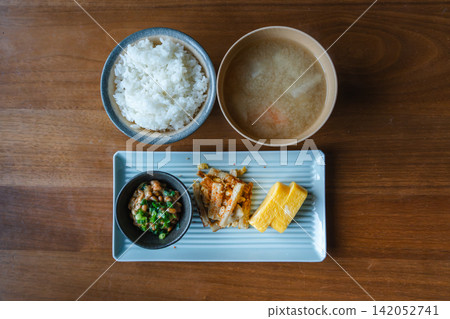 An overhead shot of a Japanese breakfast spread on a wooden table. An overhead shot of a Japanese breakfast spread on a wooden table. 142052741