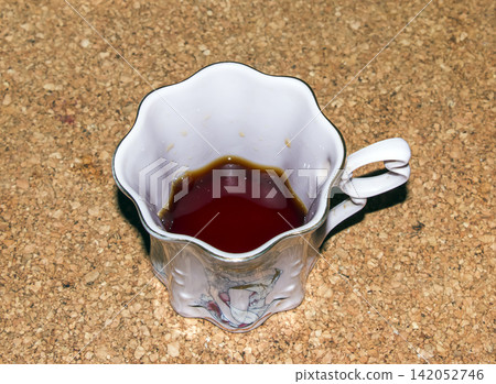 Nitra, Slovakia - July 30, 2026: Brewed Coffee in Decorative Illustrated Porcelain Cup Nitra, Slovakia - July 30, 2026: Brewed Coffee in Decorative Illustrated Porcelain Cup 142052746