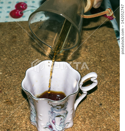 Nitra, Slovakia - July 30, 2026: Coffee Poured into Decorative Porcelain Cup Nitra, Slovakia - July 30, 2026: Coffee Poured into Decorative Porcelain Cup 142052747