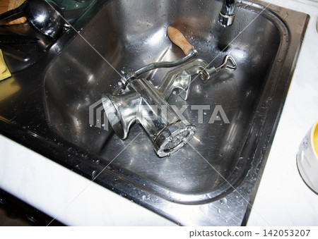 Disassembled Manual Meat Grinder in Stainless Steel Kitchen Sink 142053207