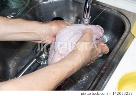 Washing Raw Poultry Meat Under Running Tap Water Washing Raw Poultry Meat Under Running Tap Water 142053232
