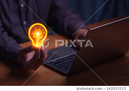 Adult man holds a glowing lightbulb over a laptop. This creative business concept represents digital technology innovation, offering a smart solution and inspiration for a new idea. Adult man holds a glowing lightbulb over a laptop. This creative business concept represents digital technology innovation, offering a smart solution and inspiration for a new idea. 142053515