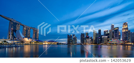 The skyscrapers of Singapore's CBD (Central Business District) at sunset (blue hour) as seen from Marina Bay. The skyscrapers of Singapore's CBD (Central Business District) at sunset (blue hour) as seen from Marina Bay. 142053629