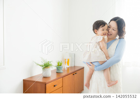 A mother holding her one-year-old daughter. A mother holding her one-year-old daughter. 142055532