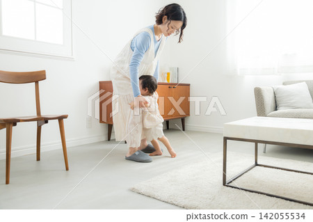 A mother holding her one-year-old daughter. A mother holding her one-year-old daughter. 142055534