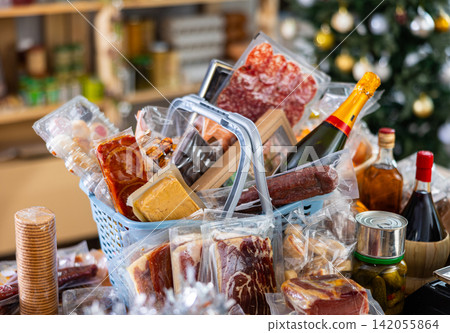 Assortment of goods on counter, basket with products on table near scale, New Year Eve Assortment of goods on counter, basket with products on table near scale, New Year Eve 142055864