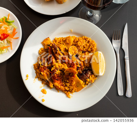Chicken and seafood paella served in traditional pan Chicken and seafood paella served in traditional pan 142055936
