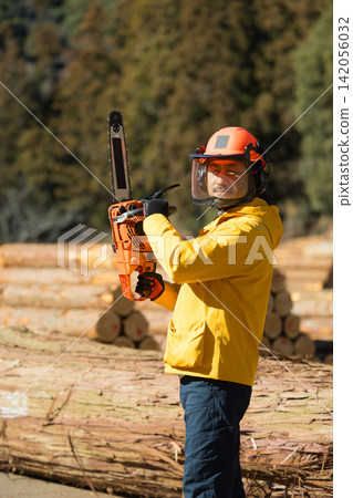 A man with a chainsaw A man with a chainsaw 142056032