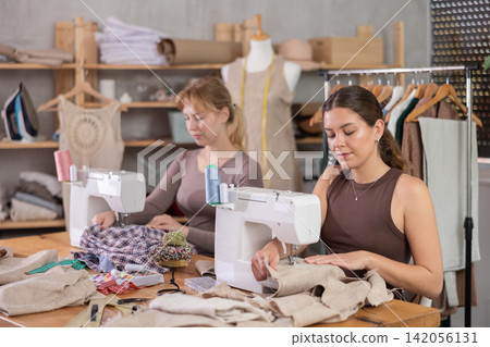 Two female tailors working in the workshop Two female tailors working in the workshop 142056131