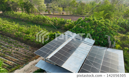 Solar panels powering a sustainable organic farm with productive crop fields, regenerative agriculture, renewable energy systems, and eco friendly food production in rural landscape. Clean energy. Solar panels powering a sustainable organic farm with productive crop fields, regenerative agriculture, renewable energy systems, and eco friendly food production in rural landscape. Clean energy. 142056305