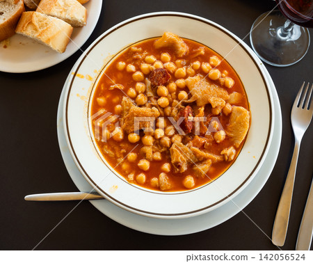 Portion of stewed tripe with chickpea is cooked in plate - stomach of cattle Portion of stewed tripe with chickpea is cooked in plate - stomach of cattle 142056524