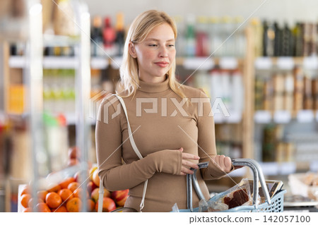 Young woman choosing food in grocery store Young woman choosing food in grocery store 142057100