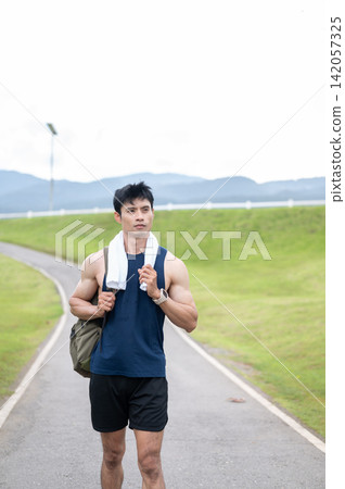 Athletic Asian Man Resting After Outdoor Run Athletic Asian Man Resting After Outdoor Run 142057325