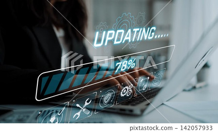 A focused business professional updates software on a laptop while a digital progress bar reflects the ongoing process, showcasing modern technology and workplace efficiency. Sigmoid A focused business professional updates software on a laptop while a digital progress bar reflects the ongoing process, showcasing modern technology and workplace efficiency. Sigmoid 142057933