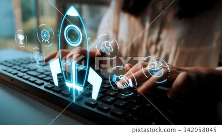 A person typing on a keyboard with abstract rocket icons symbolizing startup growth and innovation, showcasing the fusion of technology and creative thinking in the digital workspace. Sigmoid A person typing on a keyboard with abstract rocket icons symbolizing startup growth and innovation, showcasing the fusion of technology and creative thinking in the digital workspace. Sigmoid 142058045