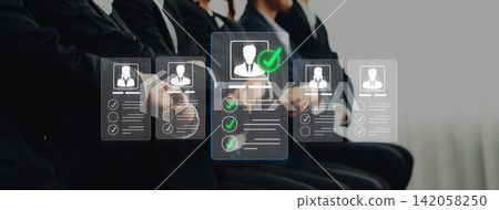 Candidates in formal attire await interviews as digital resumes and checklists appear, symbolizing the modern recruitment approach and efficiency in hiring processes. Sigmoid Candidates in formal attire await interviews as digital resumes and checklists appear, symbolizing the modern recruitment approach and efficiency in hiring processes. Sigmoid 142058250