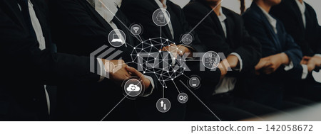 Business professionals in suits sitting in a conference room with digital network overlay and technology icons representing innovation and connectivity Trope Business professionals in suits sitting in a conference room with digital network overlay and technology icons representing innovation and connectivity Trope 142058672