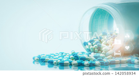 Blue and white capsules pills spilled out of white plastic bottle with medical and healthcare icon. Medical and healthcare concept. Hospital care and health insurance service. Hospital care budget. Blue and white capsules pills spilled out of white plastic bottle with medical and healthcare icon. Medical and healthcare concept. Hospital care and health insurance service. Hospital care budget. 142058934