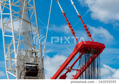 Closeup construction crane boom with lifting cables and pulley system against blue sky, heavy industrial equipment supporting infrastructure development, engineering projects and modern construction. Closeup construction crane boom with lifting cables and pulley system against blue sky, heavy industrial equipment supporting infrastructure development, engineering projects and modern construction. 142059595