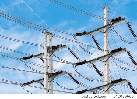 Electric power transmission lines with utility poles and ceramic insulators, electrical distribution infrastructure supporting energy supply, utility grid reliability and industrial power network. 142059606