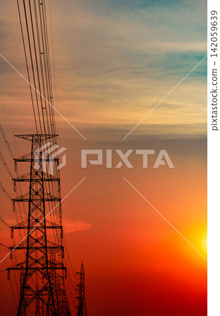 High voltage electricity transmission towers and power lines at sunset. Energy infrastructure, electrical grid, utility network, sustainable power supply and engineering. Renewable energy transition. High voltage electricity transmission towers and power lines at sunset. Energy infrastructure, electrical grid, utility network, sustainable power supply and engineering. Renewable energy transition. 142059639