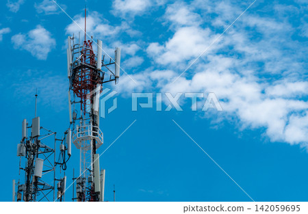 Telecommunication tower with blue sky and white clouds background. Antenna on blue sky. Radio and satellite pole. Communication technology. Telecommunication industry. Mobile or telecom 4g network. 142059695