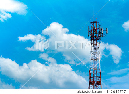 Telecommunication tower with blue sky and white clouds background. Antenna on blue sky. Radio and satellite pole. Communication technology. Telecommunication industry. Mobile or telecom 4g network. 142059727