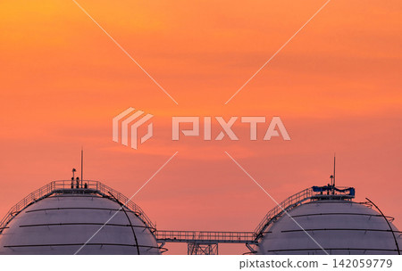 Spherical LNG storage tanks at a natural gas terminal beneath sunset sky, modern petroleum refinery infrastructure. Global energy storage, fuel supply and industrial engineering. Energy security. Spherical LNG storage tanks at a natural gas terminal beneath sunset sky, modern petroleum refinery infrastructure. Global energy storage, fuel supply and industrial engineering. Energy security. 142059779