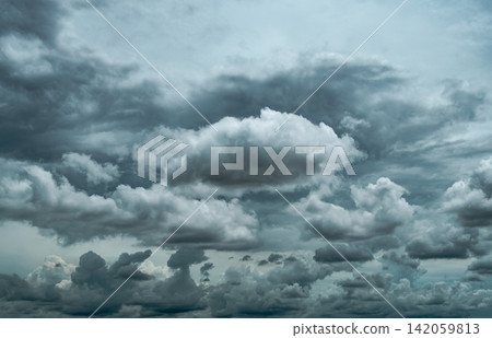 Dark dramatic storm clouds filling the sky before heavy rainfall, layered cloudscape background representing severe weather, climate change, atmospheric conditions, environmental risk and nature. Dark dramatic storm clouds filling the sky before heavy rainfall, layered cloudscape background representing severe weather, climate change, atmospheric conditions, environmental risk and nature. 142059813