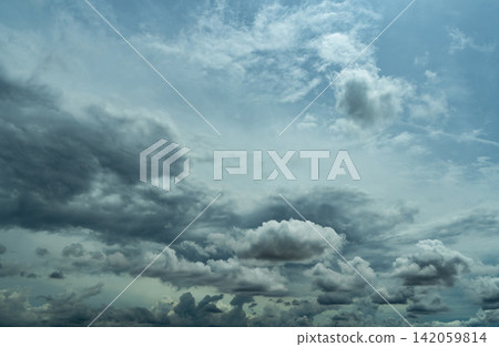 Moody gray cloudscape with textured storm clouds across the horizon, natural weather background for climate, meteorology, environmental concepts, forecast, rain and dramatic atmosphere. Moody gray cloudscape with textured storm clouds across the horizon, natural weather background for climate, meteorology, environmental concepts, forecast, rain and dramatic atmosphere. 142059814