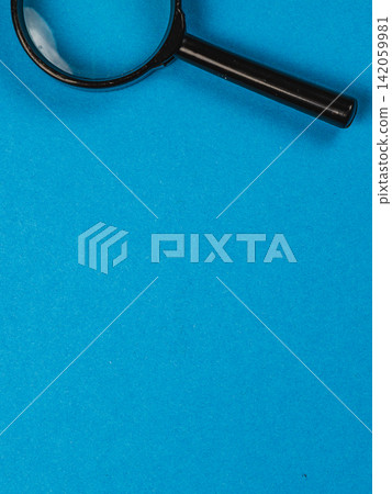 Magnifying glass on blue background for inspection and research Magnifying glass on blue background for inspection and research 142059981