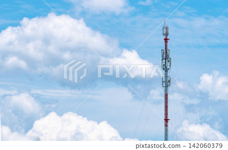 Cellular telecommunication tower with wireless antennas against dramatic blue sky. Mobile network infrastructure, broadband connectivity, digital communication technology and signal coverage. 142060379