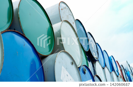Old chemical barrels. Blue and green oil drum. Empty steel oil tank. Toxic waste warehouse. Hazard chemical barrel. Industrial waste in drum container. Hazard waste storage in factory. Barrel stock. 142060687