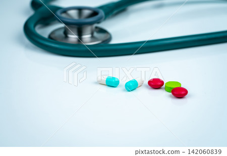 Stethoscope, capsule, and tablets pills on doctor table or nurse desk. Health checkup. Medical healthcare and medicine background. Physician tool for patient diagnosis. Cardiology doctor equipment. Stethoscope, capsule, and tablets pills on doctor table or nurse desk. Health checkup. Medical healthcare and medicine background. Physician tool for patient diagnosis. Cardiology doctor equipment. 142060839