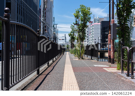 Pedestrian walkway with metal railing along riverside in Fukuoka, Japan with copy space Pedestrian walkway with metal railing along riverside in Fukuoka, Japan with copy space 142061224