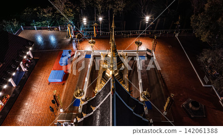 Aerial view of Phra That Doi Tung in Chiang Rai, Thailand, illuminated by warm golden lights at night in 2023. Aerial view of Phra That Doi Tung in Chiang Rai, Thailand, illuminated by warm golden lights at night in 2023. 142061388