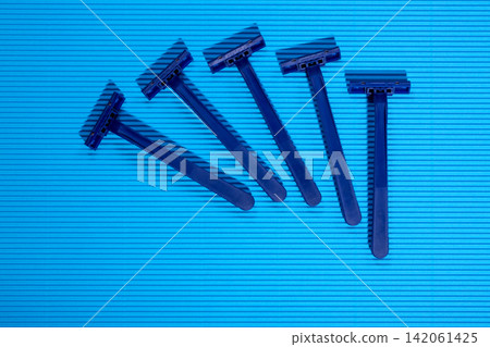 Shaving razors on a colored background Shaving razors on a colored background 142061425