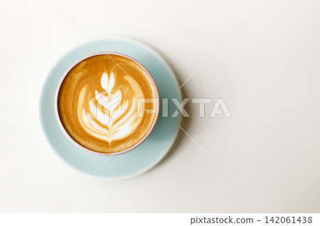 Cup of hot latte coffee on table by the window. Cup of hot latte coffee on table by the window. 142061438